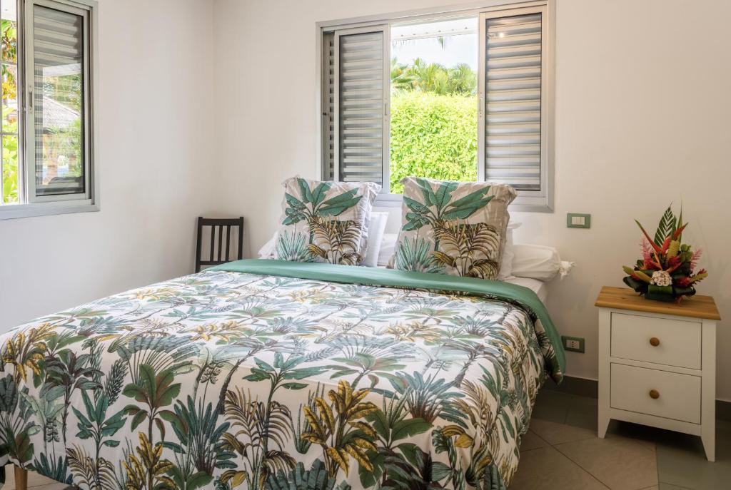 波拉波拉PARADISE的一间卧室配有一张带热带床罩的床