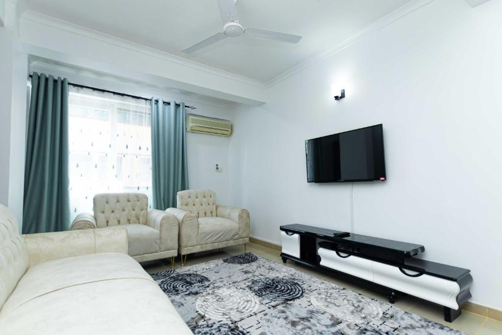 达累斯萨拉姆Kay's Place的客厅配有2张沙发和1台平面电视