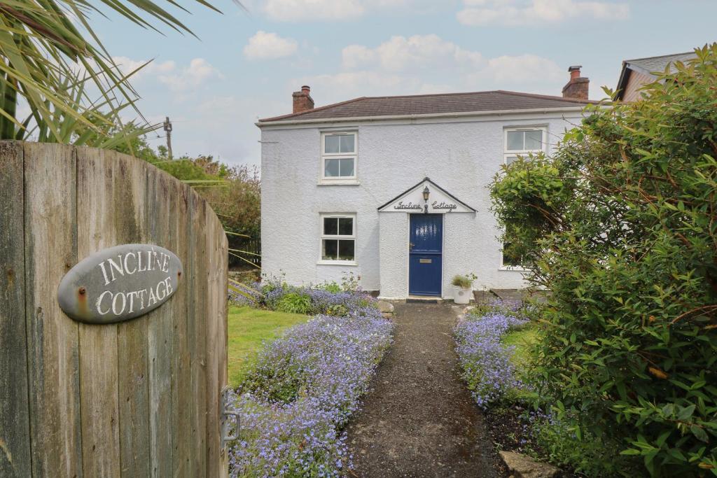 波特里斯Incline Cottage的白色的房子,有蓝色的门