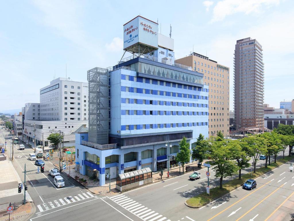 秋田秋田竿灯大街珍珠城市饭店的一座高大的蓝色建筑,上面有一座塔
