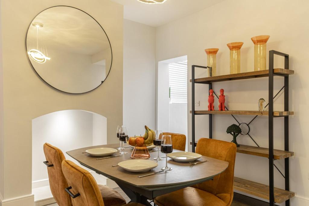 HugglescoteSparkenhoe House的一间带桌椅和镜子的用餐室