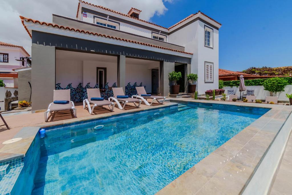 阿罗纳Villa De Marcos的一座带游泳池和房子的别墅