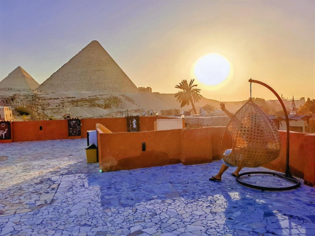 开罗Energy Of Pyramid Hotel的金字塔前的鸟雕像
