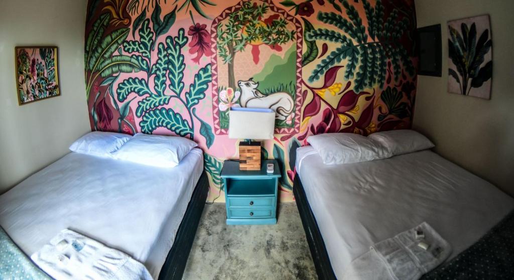 奥莫阿Sunset Hut Hostel的色彩缤纷的墙壁内的两张床