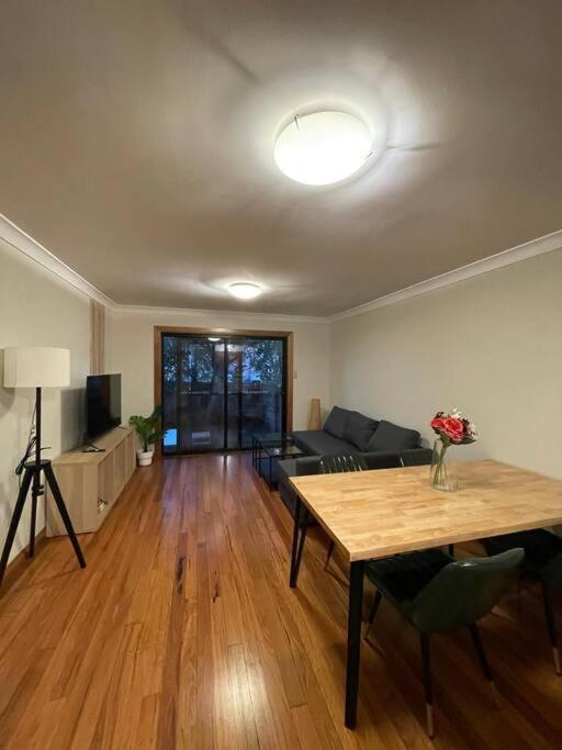 悉尼Comfortable 3 Bedroom House Pyrmont的客厅配有桌子和沙发