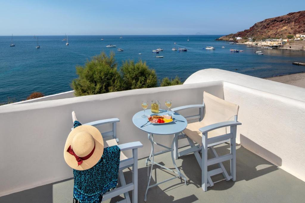 阿克罗蒂里阿克罗蒂里酒店的俯瞰大海的阳台配有桌椅