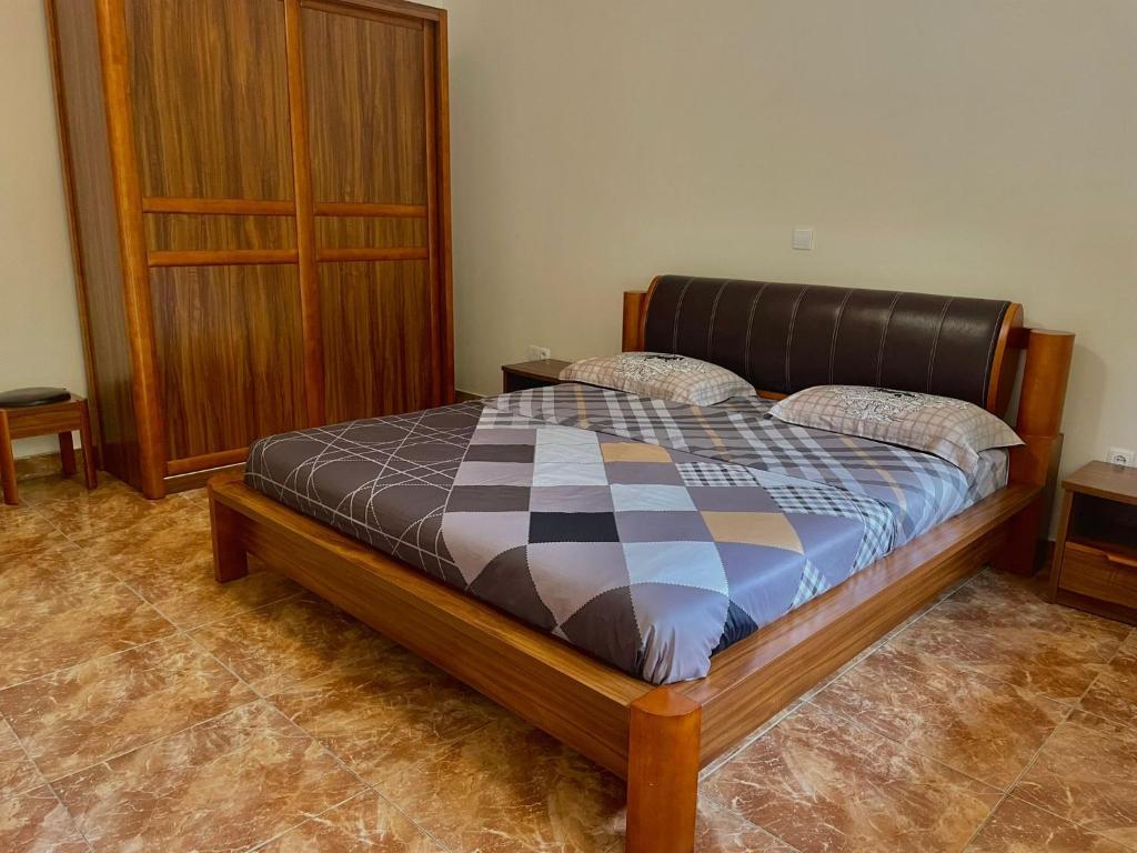 卢班戈Mapunda House的一间卧室配有一张床和一个木制橱柜