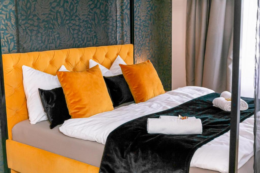 奥尔登堡CABANA City-Center - Küche - Netflix - Parkplatz的一张带橙色床头板和枕头的床