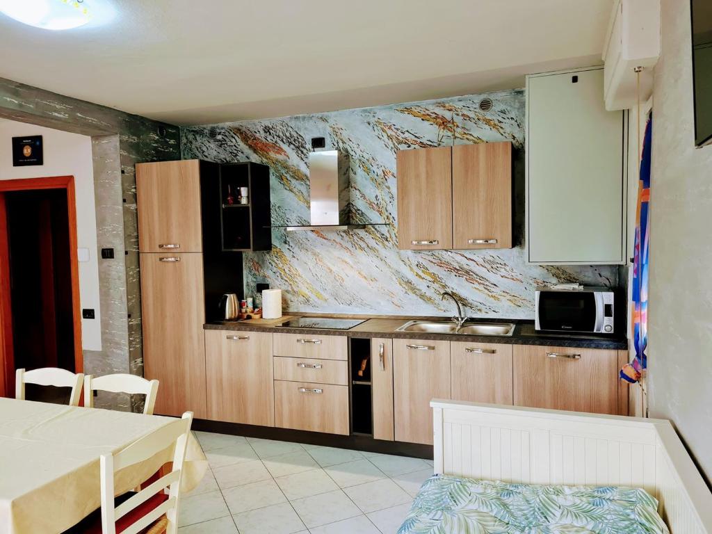 萨莱马拉西诺Kidonia - Iseo Lake Apartmens的厨房配有木制橱柜和台面