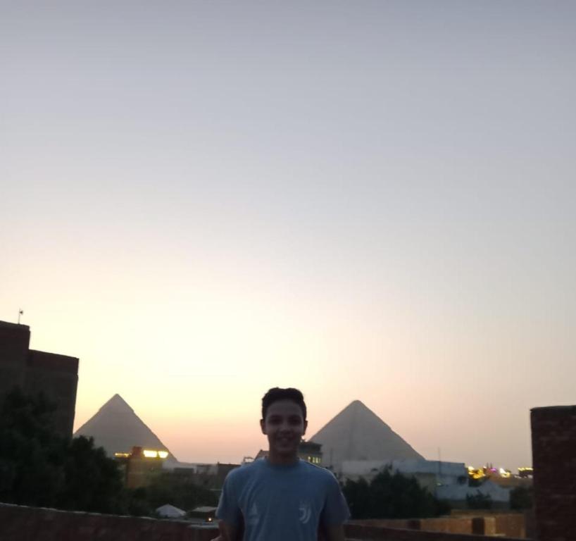 开罗Nana Pyramids Guest House的站在金字塔前的人