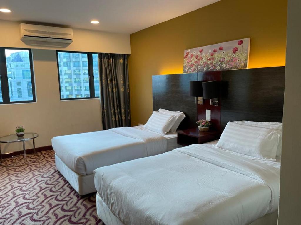 哥打京那巴鲁KK Homestay City Deluxe room - Ming Garden Hotel & Residence的一间酒店客房,房间内设有两张床