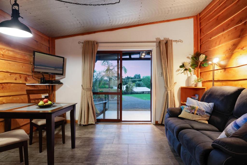 陶朗加Swiss-Kiwi Retreat A Self-contained Appartment or a Tiny House option的客厅配有沙发和桌子