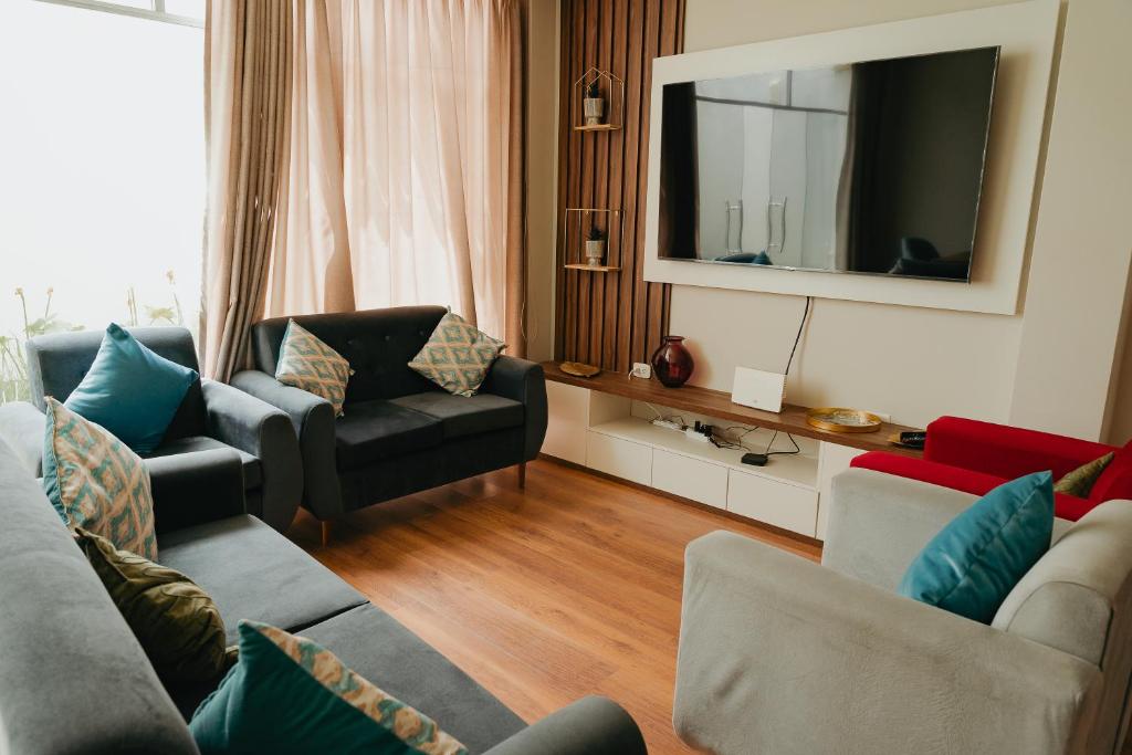 卡哈马卡Cajamarca Home Family Centric Parrilla 4BR的客厅配有两张沙发和一台电视