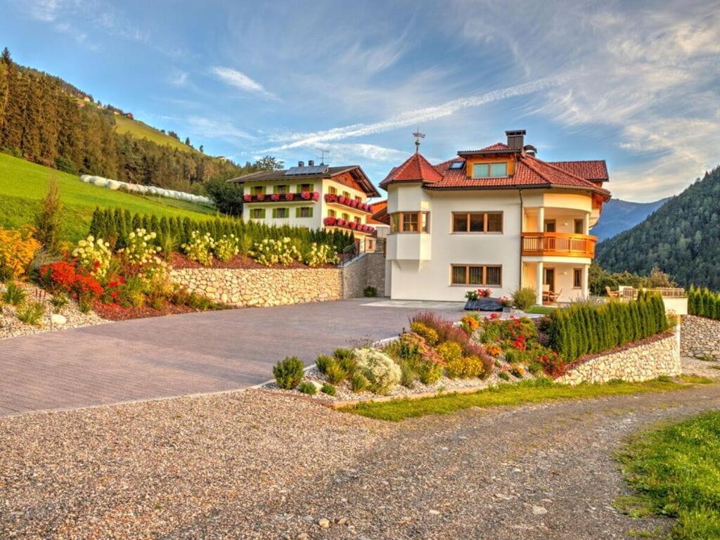 FloronzoHoliday apartment in St Lorenzen的山丘上带车道的房子