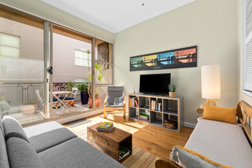 悉尼'Laube 105' Modern Inner-city Sanctuary with Balcony的带沙发和电视的客厅