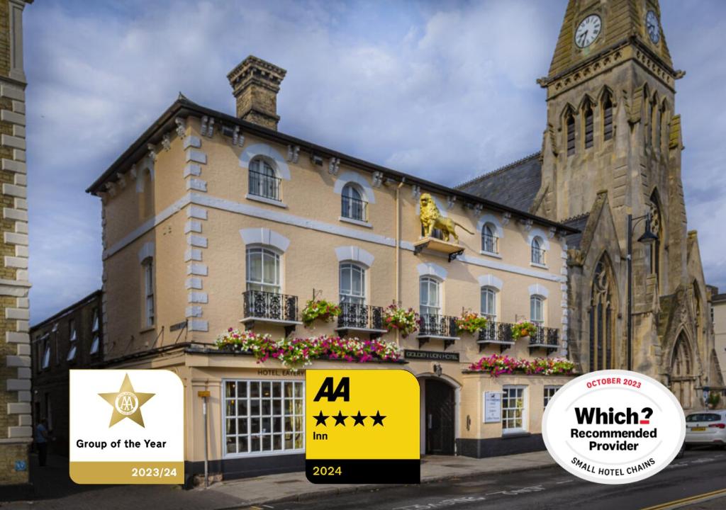 圣艾夫斯The Golden Lion Hotel, St Ives, Cambridgeshire的一座大建筑,前面有一个钟楼