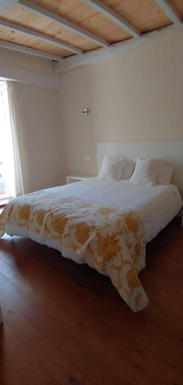 CamponarayaHostal Camponaraya的一间卧室配有一张带棕色和白色毯子的床