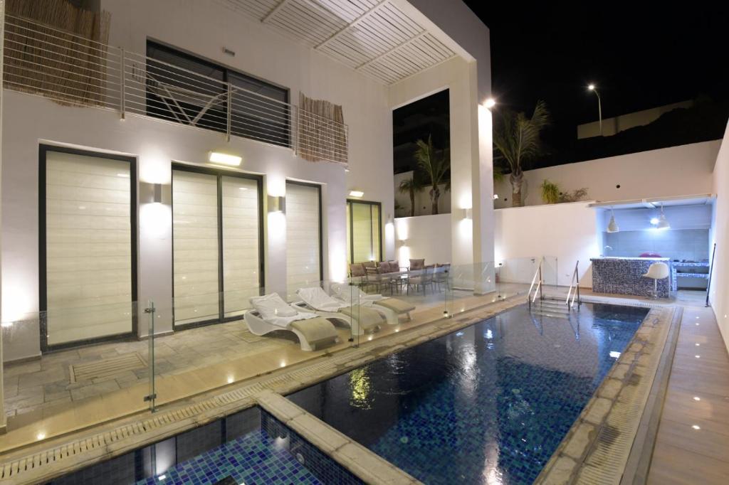 埃拉特New ! 430m Luxury Best Top Class 8-Bdr Exclusive Villa Top Design HEATED Pool Jucuzzi Sauna的一座带游泳池和房子的房子