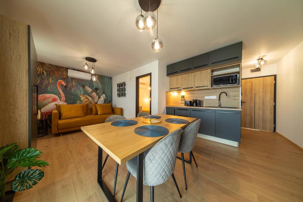 苏提万The Good Place的一间厨房和客厅,客厅内配有木桌。