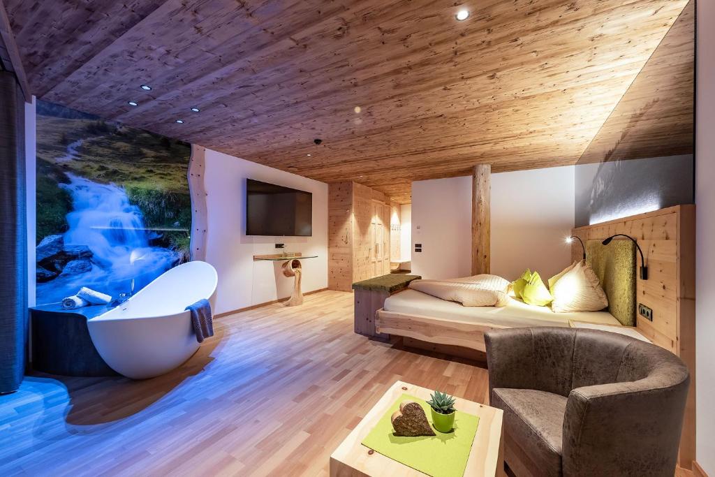 卡斯特尔罗托Luxury and Nature House Moarlhof的带浴缸和床的酒店客房