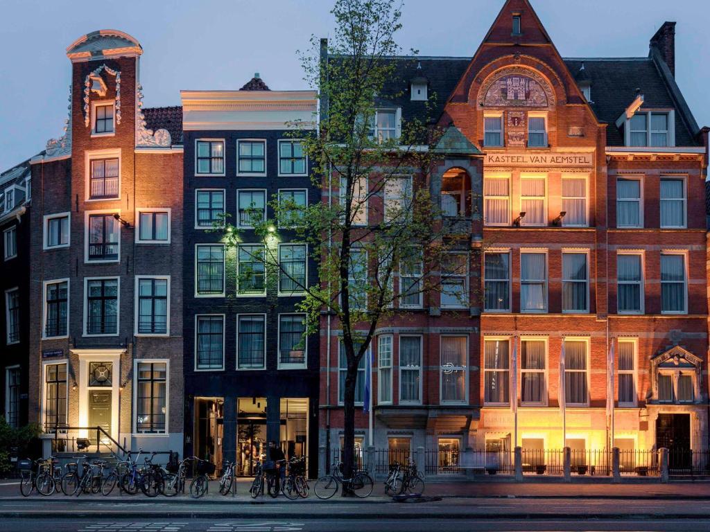 阿姆斯特丹INK Hotel Amsterdam - MGallery Collection的一群自行车停在他们前面的建筑
