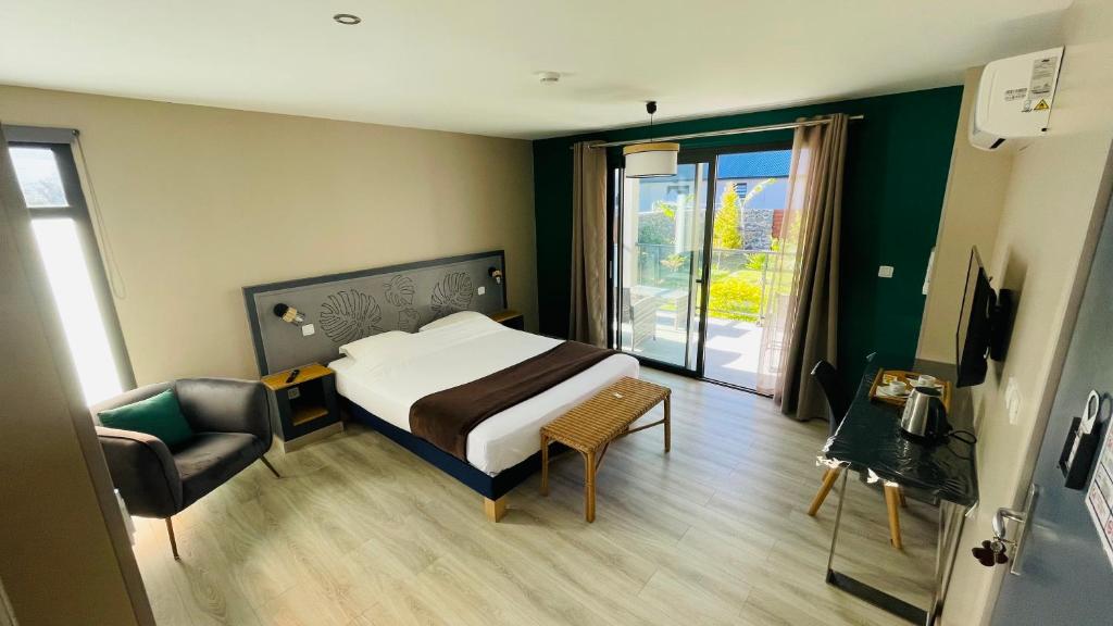 锡拉奥La Villa Kazuera的卧室配有床、椅子和窗户。