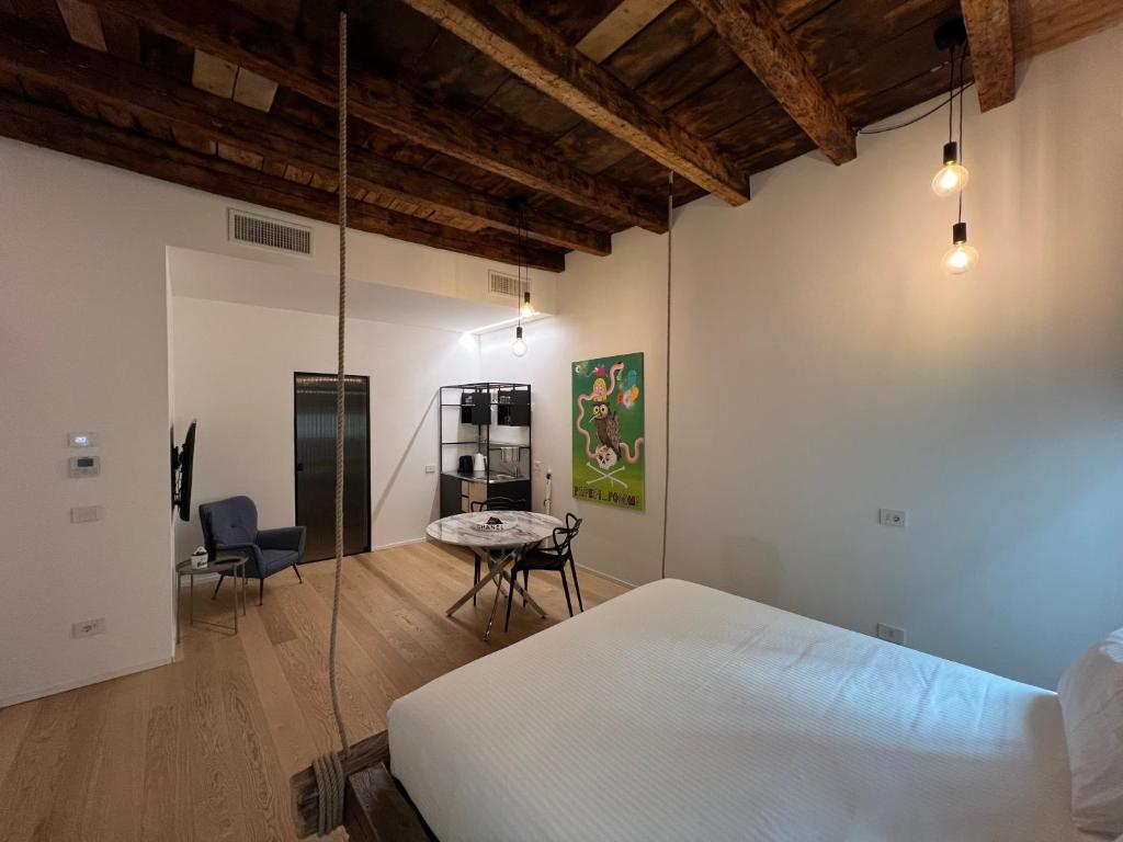 洛韦雷Dream Suite Lago D’iseo的卧室配有一张床和一张桌子及椅子