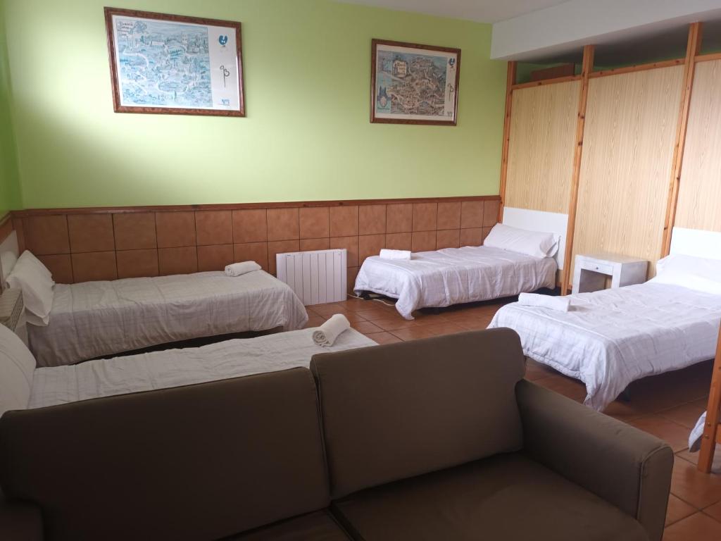 阿尔苏阿A CONDA的一间设有三张床的房间,其中一张沙发