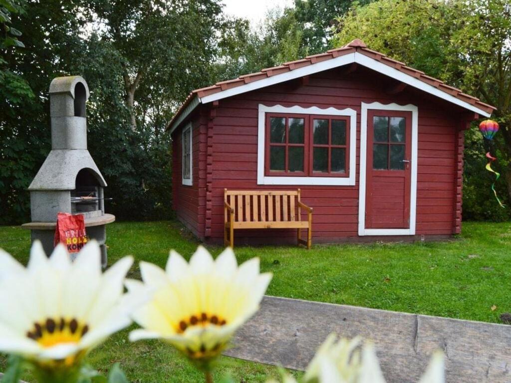 诺德代希Deichjuwel Comfortable holiday residence的院子里有带长凳的红色棚子