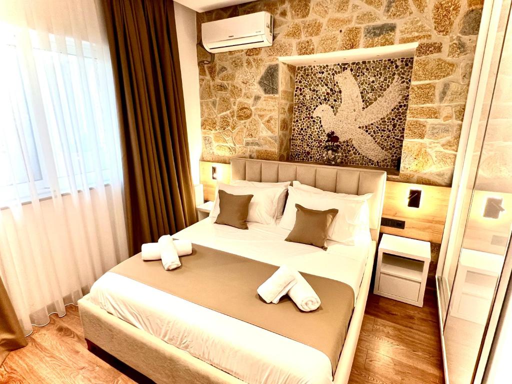 卡萨米尔ILLYRIAN hotel的卧室配有带毛巾的大型白色床