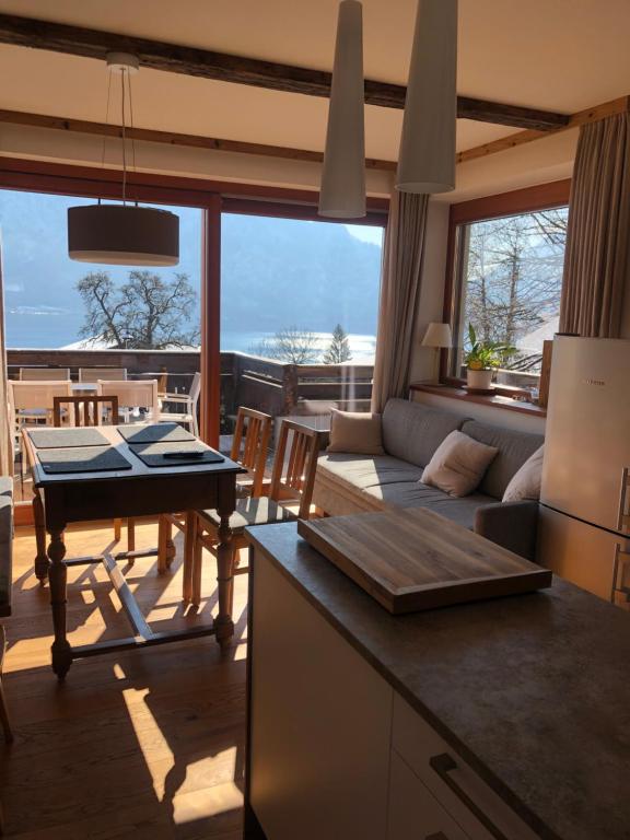 阿特湖畔翁特拉赫克里斯蒂娜公寓的厨房以及带沙发和桌子的客厅。