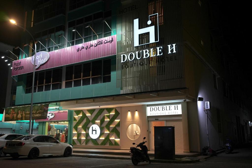 瓜拉丁加奴Double H Boutique Hotel的停在前面的一座带摩托车的建筑