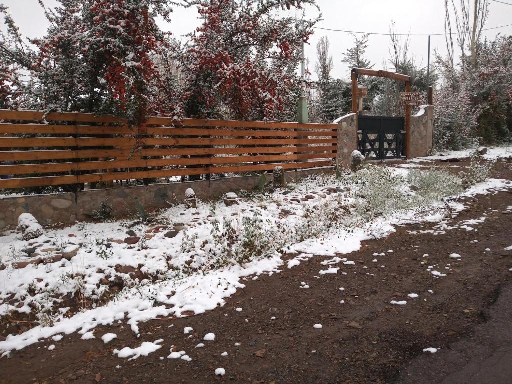 波特雷里约斯Cabañas Rowal的一条雪覆盖在道路旁的栅栏