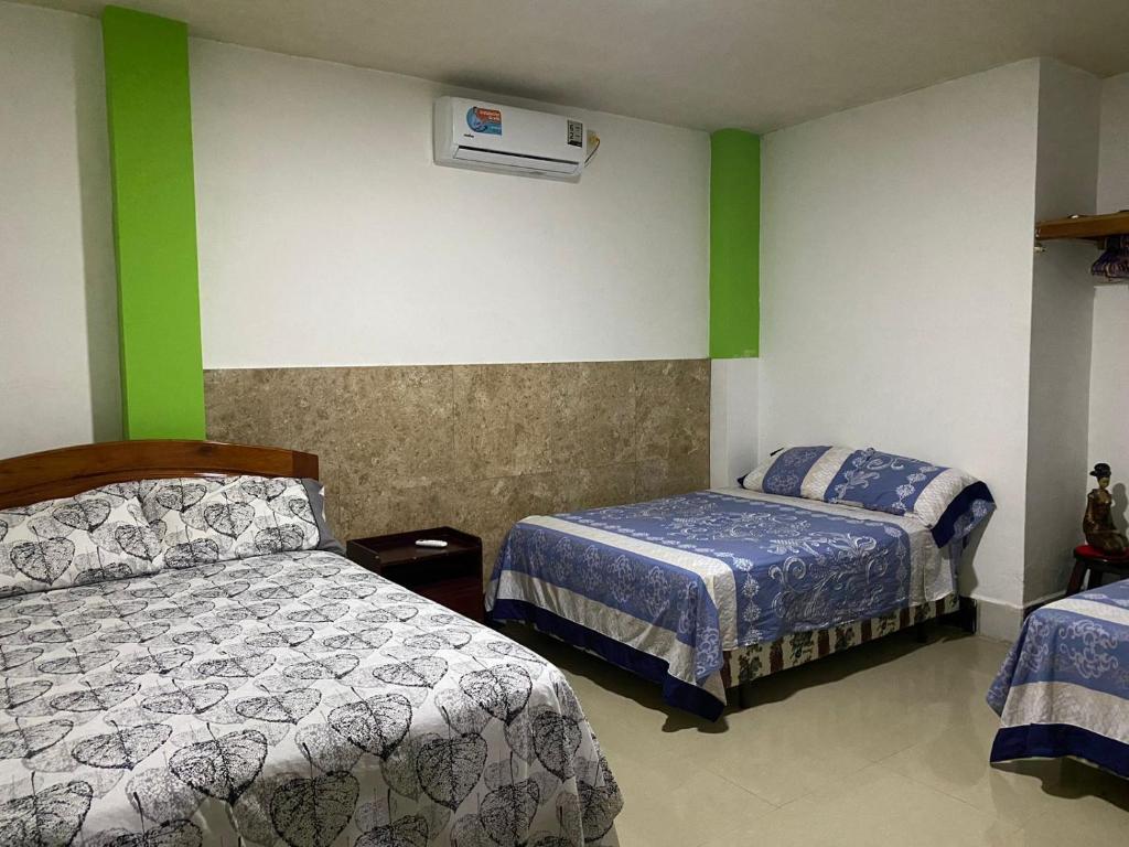 巴克里索莫雷诺港Casa en san Cristobal的一间卧室配有两张床和空调。