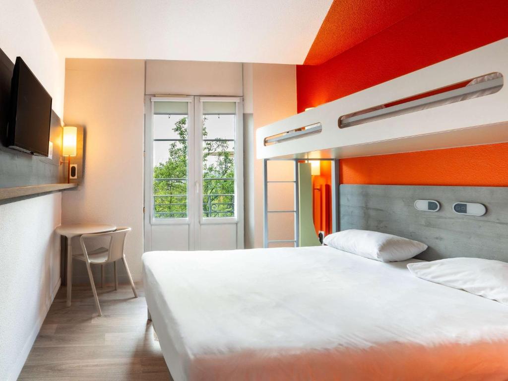 斯特拉斯堡斯特拉斯堡中心火车站宜必思快捷酒店的卧室配有白色的床和橙色的墙壁