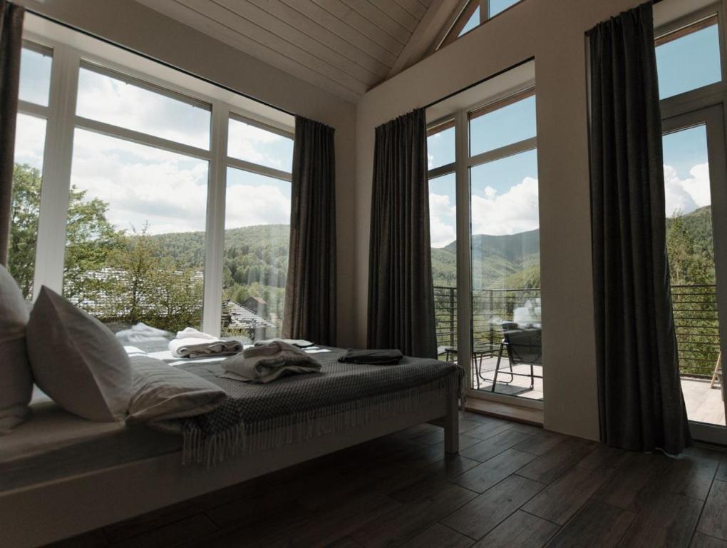 亚列姆切Apart-hotel Vershina的一间卧室设有一张床和一个大窗户