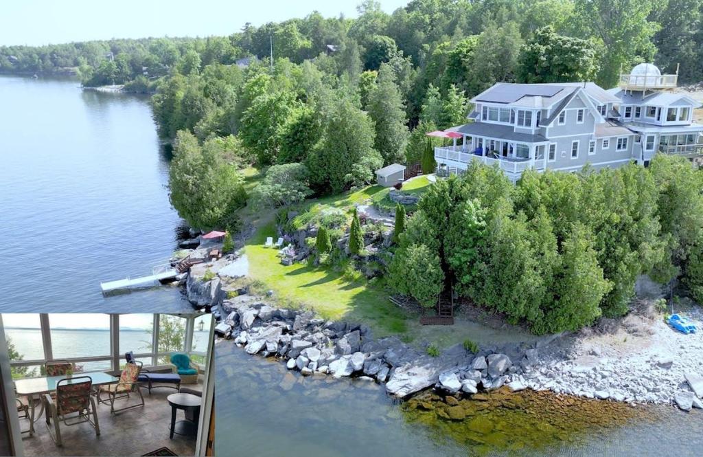 普拉茨堡Loza house adirondack screened-in porch unit lake front的水中岛上大房子的空中景观