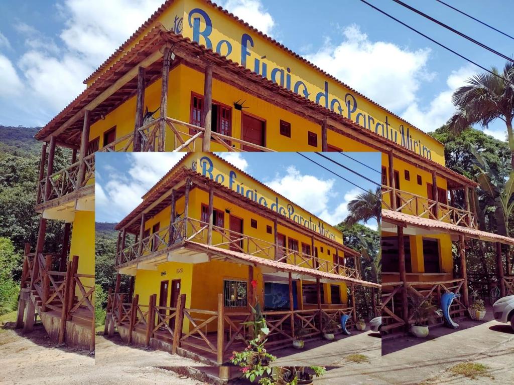 帕拉蒂Refugio Do Paraty Mirim的黄色的建筑,上面有标志