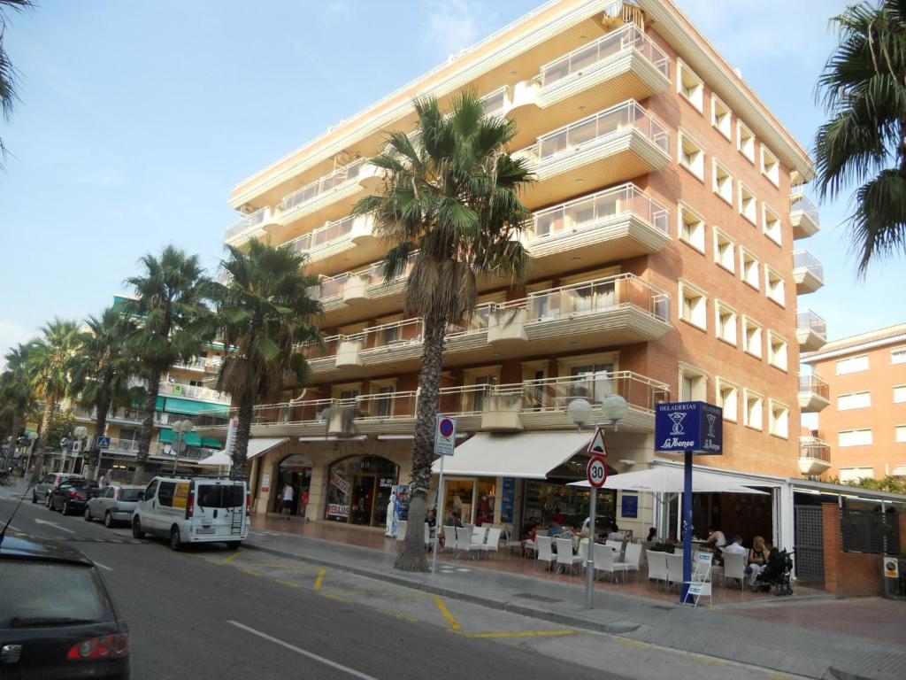 萨洛萨鲁帕拉斯公寓的一条街道前方有棕榈树的高楼