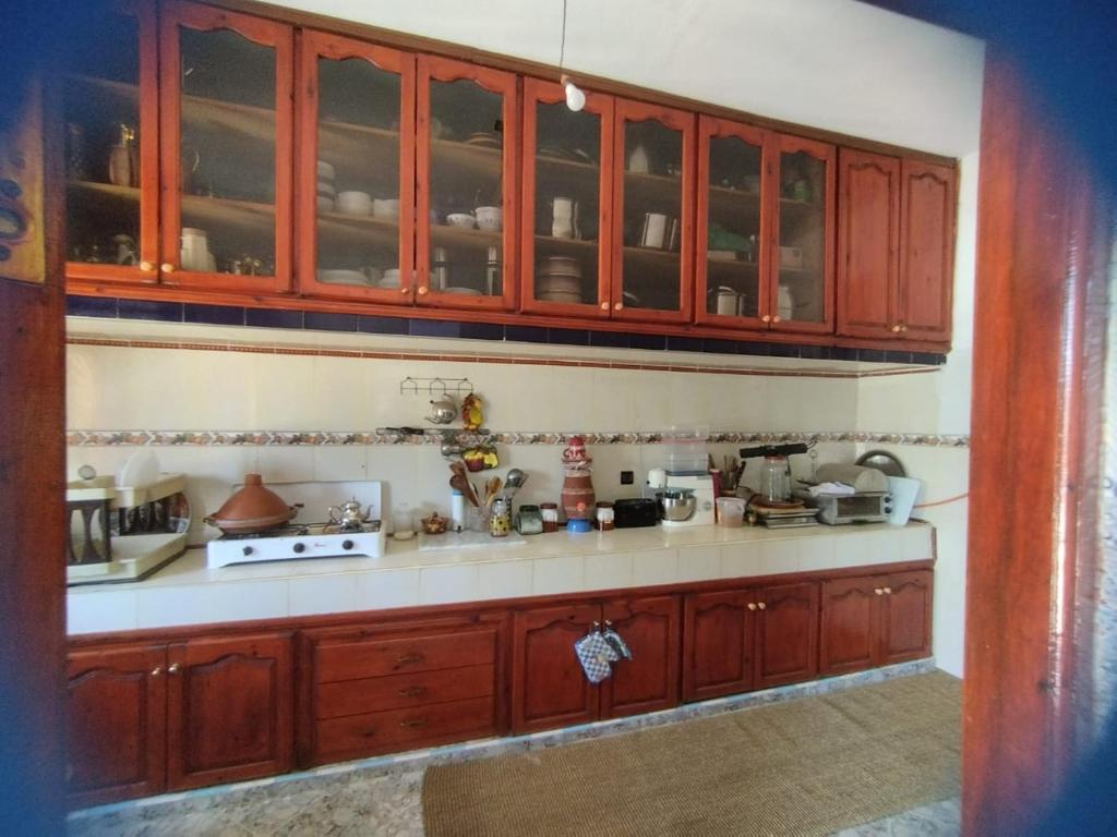 Aït SaïdFerme Abdou的厨房配有木制橱柜和白色台面