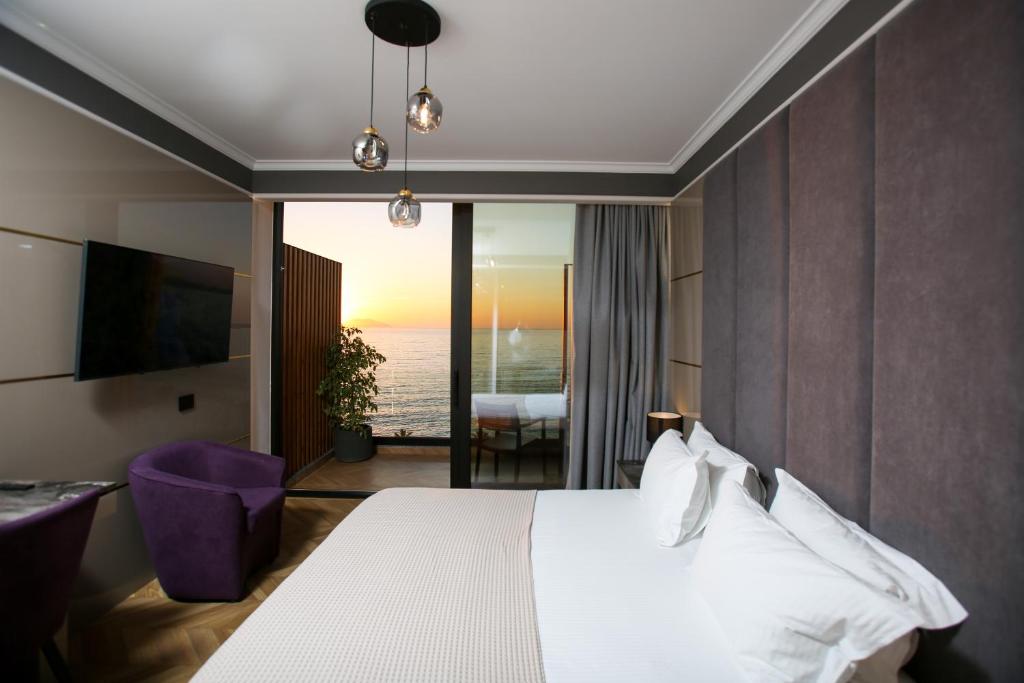 伏罗拉Belvedere Hotel的一间卧室配有一张床,享有海景
