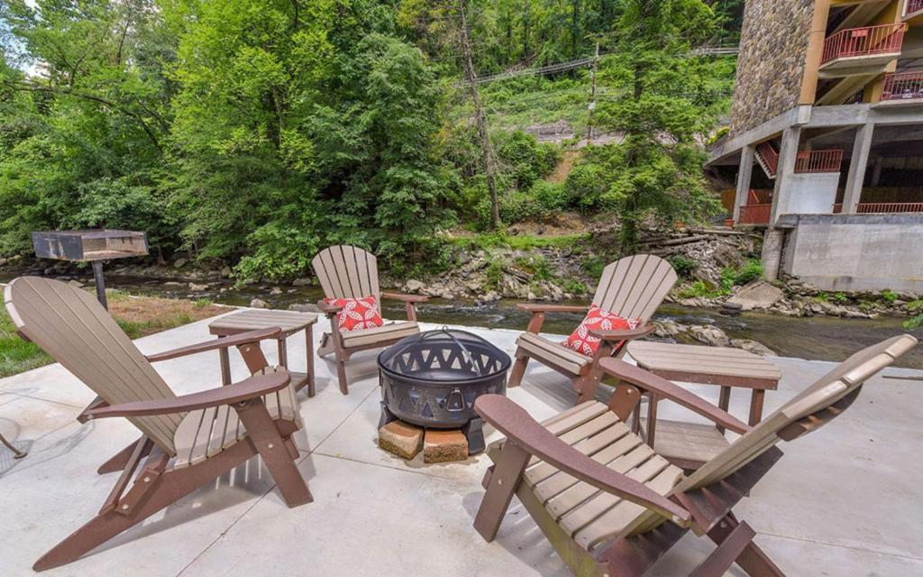 加特林堡River Romance的庭院里设有三把椅子和一个火坑