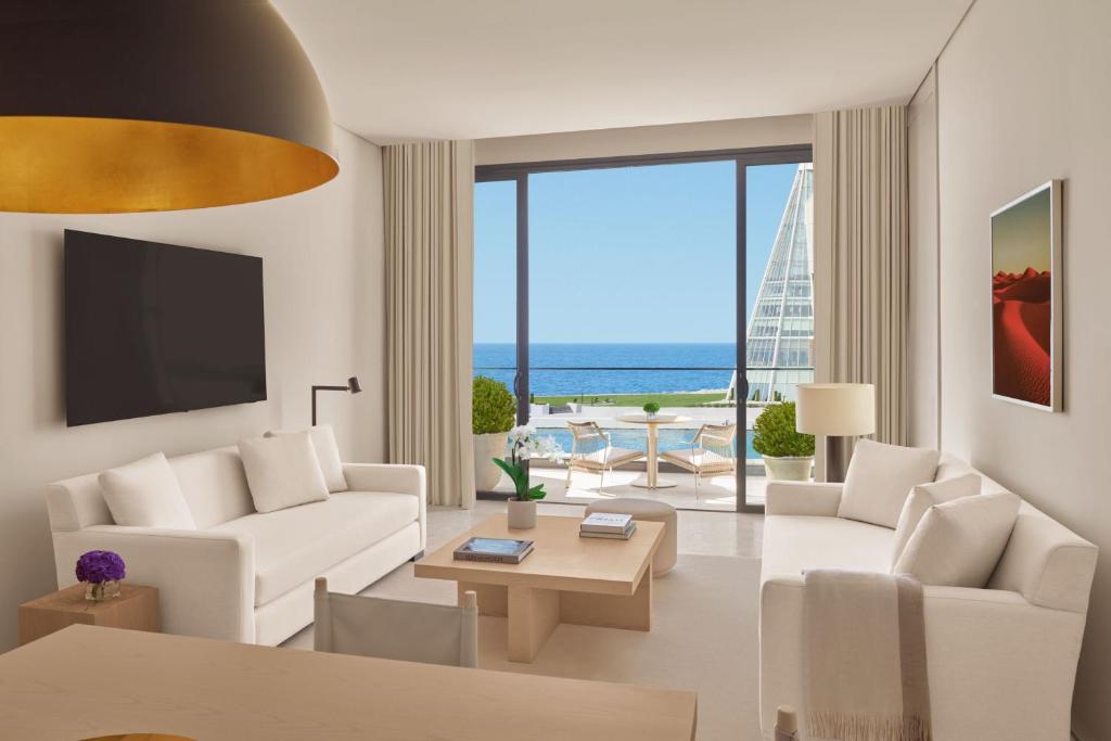 吉达The Jeddah EDITION的客厅配有白色家具,享有海景。