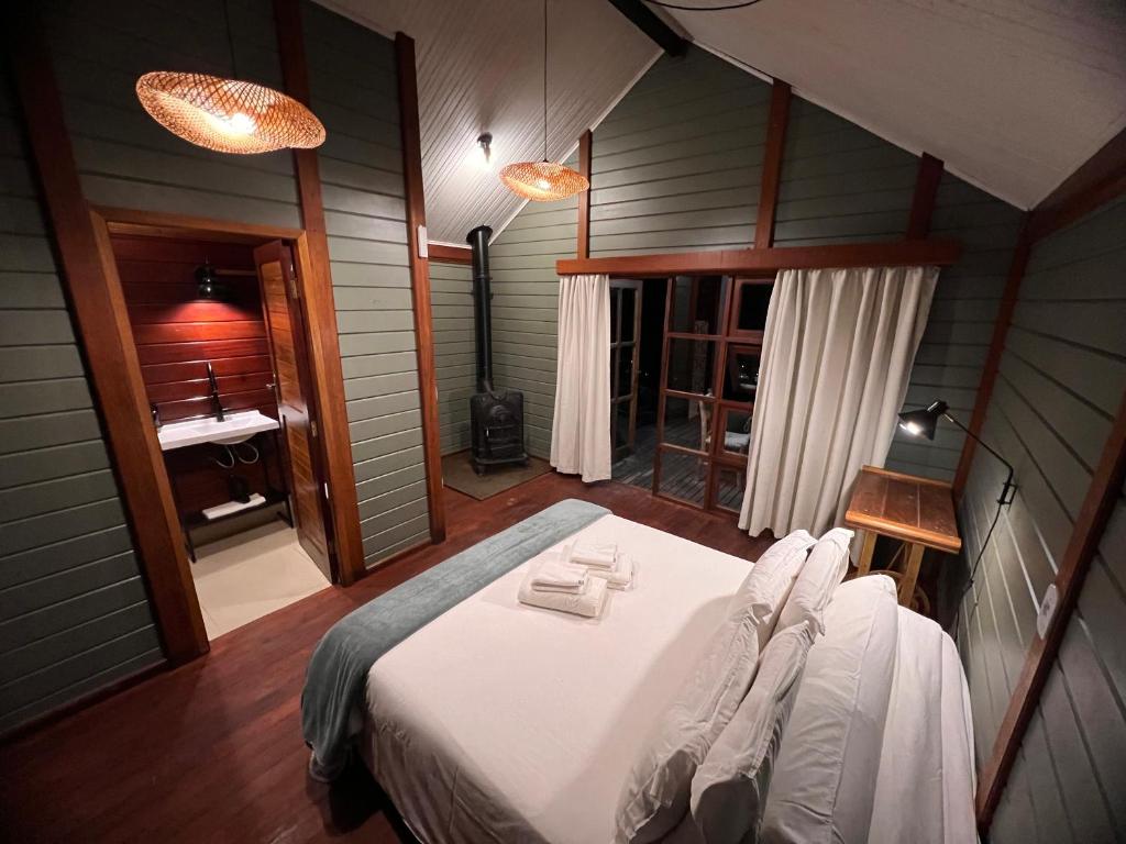 圣安东尼奥-杜皮尼亚尔Reserva Santo Antônio的卧室配有一张白色大床