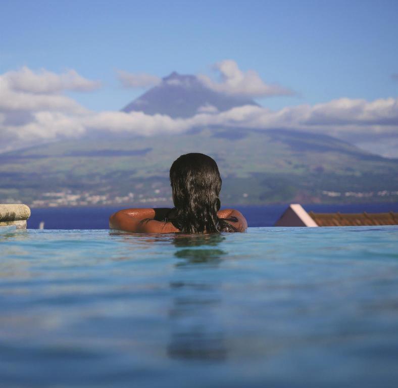 奥尔塔法亚尔阿佐利斯花园度假酒店的坐在游泳池的水中的女人