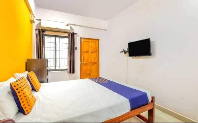 阿姆波尔SPOT ON 63651 Red Rocks Guest House的卧室配有一张床,墙上配有电视。