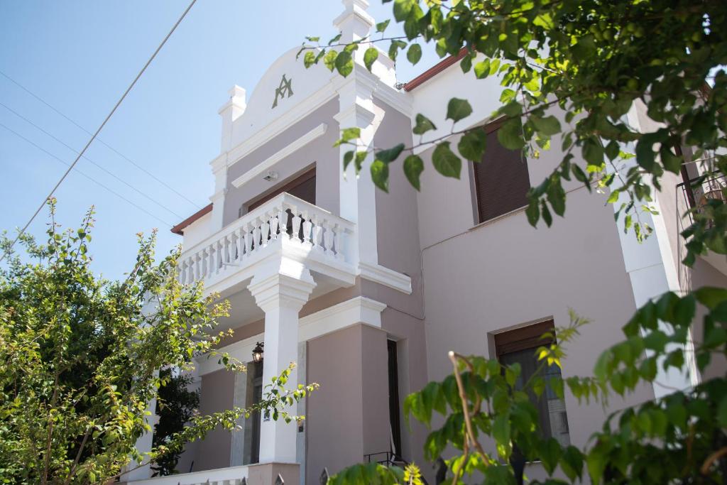 萨索斯Acropolis Hotel的白色的建筑,上面设有阳台