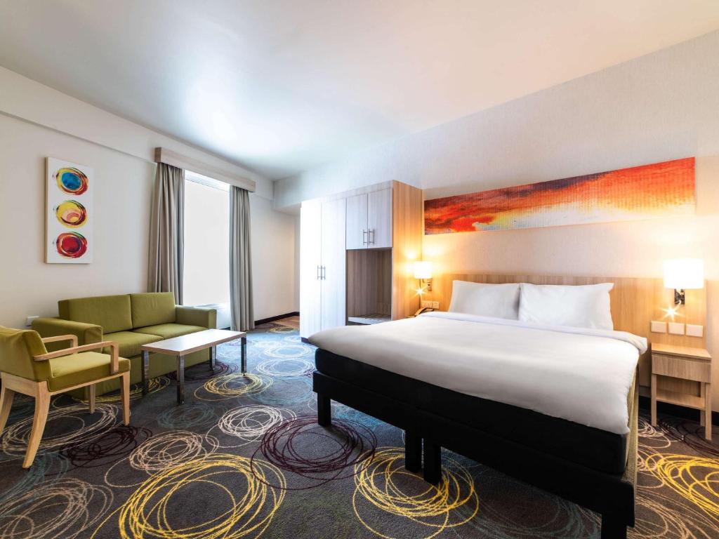 迪拜迪拜龙城宜必思尚品酒店的酒店客房,配有床和沙发