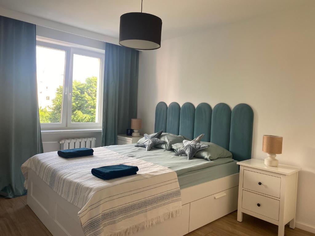 兹沃图夫Złotów 9的一间卧室配有一张大床和蓝色床头板