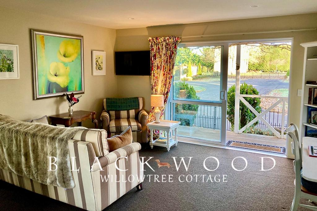 林肯Willow Tree Cottage的带沙发和滑动玻璃门的客厅